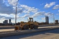 Front-end loader working at construction site on road work. Earth-moving heavy equipment and construction machinery. Laying Royalty Free Stock Photo