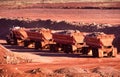 Front end loaders and dump trucks moving ore