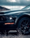 the front end of a sports car parked near a mountain Royalty Free Stock Photo