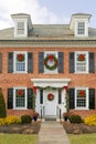 historic professional building shutters windows decorated with Christmas wreaths Royalty Free Stock Photo