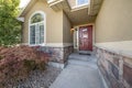 Front exterior of a house with half stone wall siding