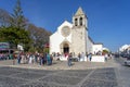 front facade of the main church in the municipality of alcochete with numerous people celebrating for Easter reasons