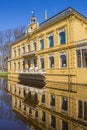 Front facade of the Nienoord mansion with reflection in the water in Leek