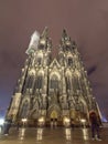 Front facade of the Roman Catholic cathedral of Cologne or High Cathedral of Saint Peter at night.