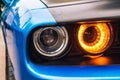The front double headlight of a sports blue car. Orange headlight Royalty Free Stock Photo