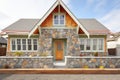 front gable view of shingle house with stone groundwork Royalty Free Stock Photo