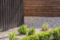 Design of the property with wooden fence, rolled gravel and individual plants