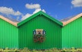 Front of green boat houses with traditional bavarian window