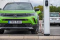 Front of a green Opel Mokka charging at a public charger.. Royalty Free Stock Photo