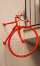 The front half of a vintage red bicycle pinned to the wall of a minimalist building block Royalty Free Stock Photo