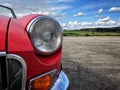 Front headlamp of red MGB raodster Royalty Free Stock Photo