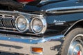 Front and headlight of blue vintage Mercury Meteor car at a show