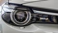 Front headlight of a modern car. Light gray color. Close-up Royalty Free Stock Photo