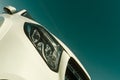 Front headlight of modern prestigious white color car close up Royalty Free Stock Photo