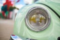 The front headlight of the old cute car, green