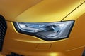 Front headlights of the luxury golden car