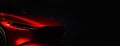 Front headlights of red modern sport car on black background Royalty Free Stock Photo