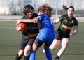 Front on high and hold upper body tackle during rugby women match playgame