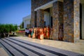 in front of the hotel the colorfully dressed indian wedding party is waiting for the arrival of the bride and groom