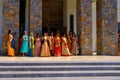 In front of the hotel the colorfully dressed indian wedding party is waiting for the arrival of the bride and groom