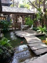 In front of the house there is a walkway and a fish pond Royalty Free Stock Photo