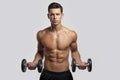 Front image of a confident young man shirtless torso portrait training with dumb-bell, isolated white background.