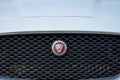 Front Jaguar logo of a wjite 2018 Jaguar F-Pace..
