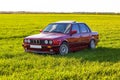 Front left side of an old German car that stands on green grass at sunset Royalty Free Stock Photo