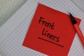 Front Liners write on sticky notes isolated on Wooden Table Royalty Free Stock Photo