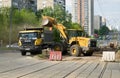 The front loader loads the sand into the dump truck