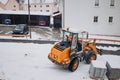 Front Loader Operator Transporting Construction Materials in Winter Royalty Free Stock Photo