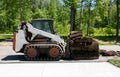 Front loader and a pallet with rolls of sod grass for installation Royalty Free Stock Photo