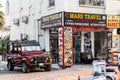 Front look of Land Rover Defender prepared for off-road driving, stands near tourism agency