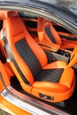 Front luxury car seat. Orange car interior Royalty Free Stock Photo