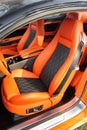 Front luxury car seat. Orange car interior. Royalty Free Stock Photo