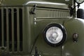 Front mask of four-wheel drive Soviet off-road military vehicle GAZ69 with round headlights and massive front grille