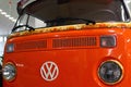 Front mask of legendary hippie van, Volkswagen Transporter from year 1975, orange colour with flower design