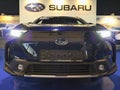 Front mask and lit LED headlights on modern japanese battery electric compact crossover SUV car Subaru Solterrra