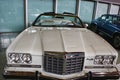 Front mask with massive chrome grille and twin round headlights of american full-size car Pontiac Grand Ville from year 1973