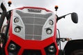 Front mask of modern large agricultural tractor McCormick X7 623 with six round headlights on front.