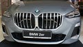 Front mask of modern subcompact executive car BMW 2er, possibly U06 in dark silver metallic colour, displayed on motorshow.