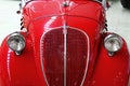 Front mask of red oldtimer Italian city car Fiat 500 Topolino little mouse launched in 1936 Royalty Free Stock Photo