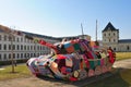 In front of the military history museum in Dresden city there is a colourfull peace tank as a protest against war world wide