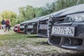 Front nose of an Alfa Romeo 159 in focus, 156 in foreground. Multiple black cars lined up in a field. Parked as a part of an Royalty Free Stock Photo