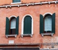 Front old red brick wall building with shutters window. European architecture. Royalty Free Stock Photo