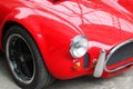 Front of old red car close up with round car headlight Royalty Free Stock Photo