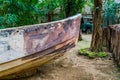 The front a old rowing boat in a tropical jungle scenery, water transportation, nautical background