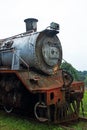 FRONT OF OLD RUSTED STEAM LOCOMOTIVE AT AN ABANDONED STATION Royalty Free Stock Photo