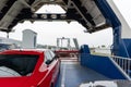 Front open door of passenger freight cargo ferry boat vessel ship with loaded cars and vehicles. Sea transportation Royalty Free Stock Photo