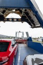 Front open door of passenger freight cargo ferry boat vessel ship with loaded cars and vehicles. Sea transportation Royalty Free Stock Photo